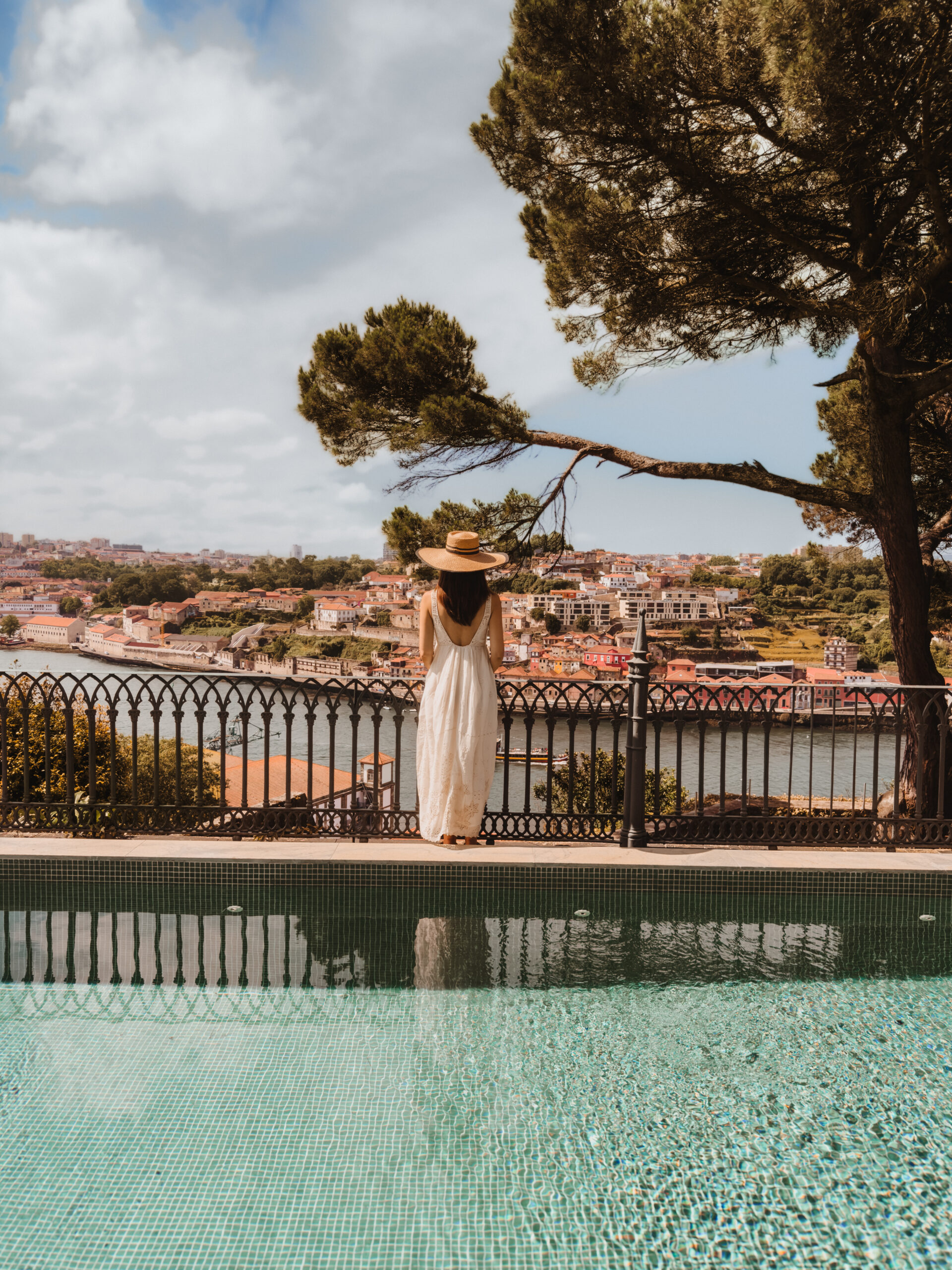 Woman by the private river-view pool of the Alfred Hitchcock Maisonette at Torel Avantgarde, a luxury hotel in Porto, Portugal.